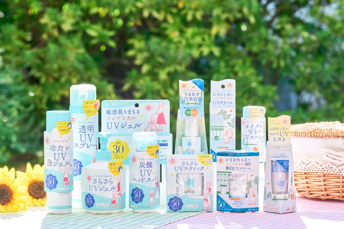 屋外の緑豊かな背景に、ノンケミカル、敏感肌向け、子どもも使えるUVケア製品が多数並んでいます。