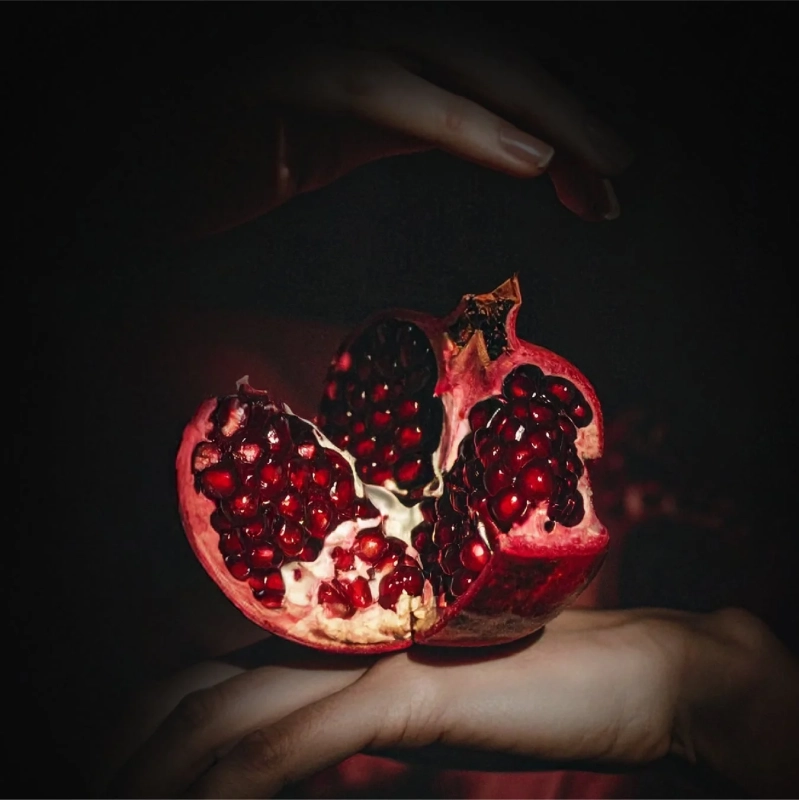 割れたザクロと手